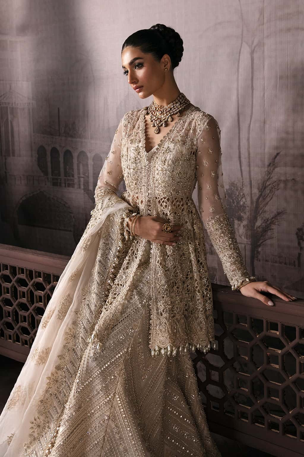 Luxurious organza suit featuring hand-embellished panels, embroidered dupatta, and raw silk trouser — perfect for festive and formal occasions.