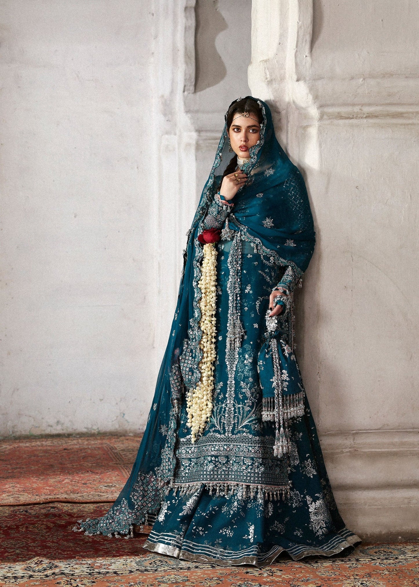 Graceful teal organza shirt with fine embroidery, silk sharara, and chiffon dupatta. Unstitched festive outfit perfect for elegant traditional occasions.