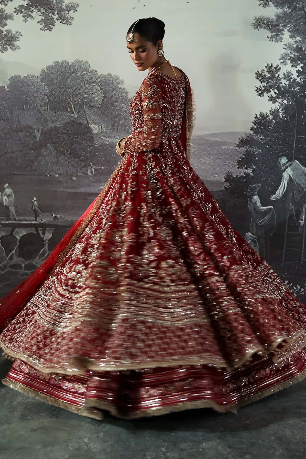 Luxurious net suit with hand-embellished panels, embroidered dupatta with motifs, and raw silk trouser — perfect for weddings and festive wear.