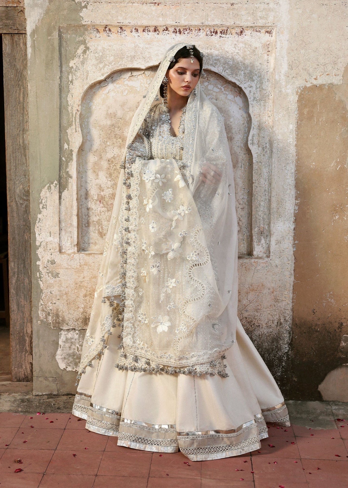 Elegant ivory organza shirt with sequin embroidery, silk sharara, and chiffon dupatta. Unstitched luxury outfit exuding timeless grace and sophistication.