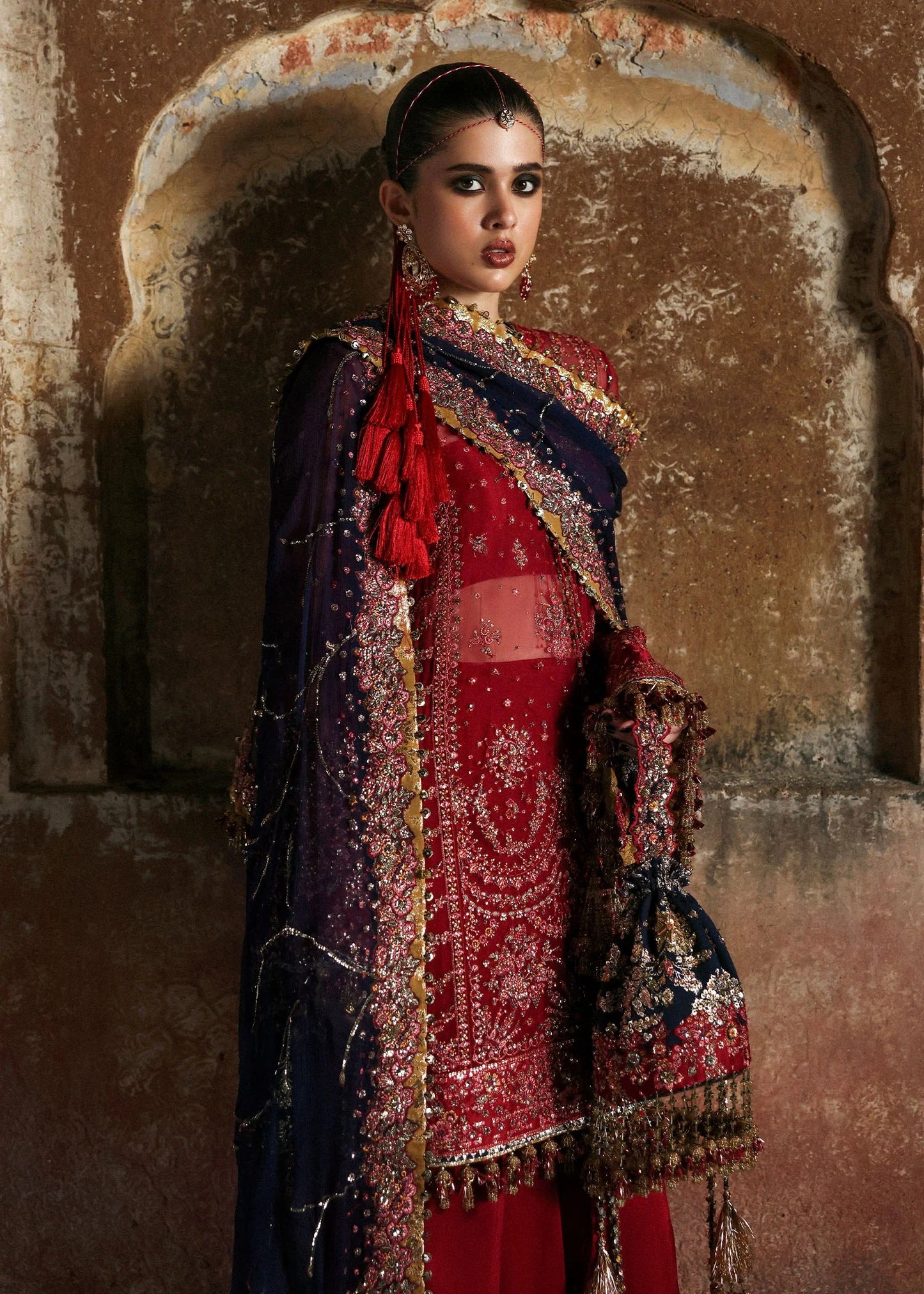 Stunning cherry red chiffon shirt with rich embroidery, silk shalwar, and chiffon dupatta. Unstitched festive outfit radiating elegance and timeless grace.