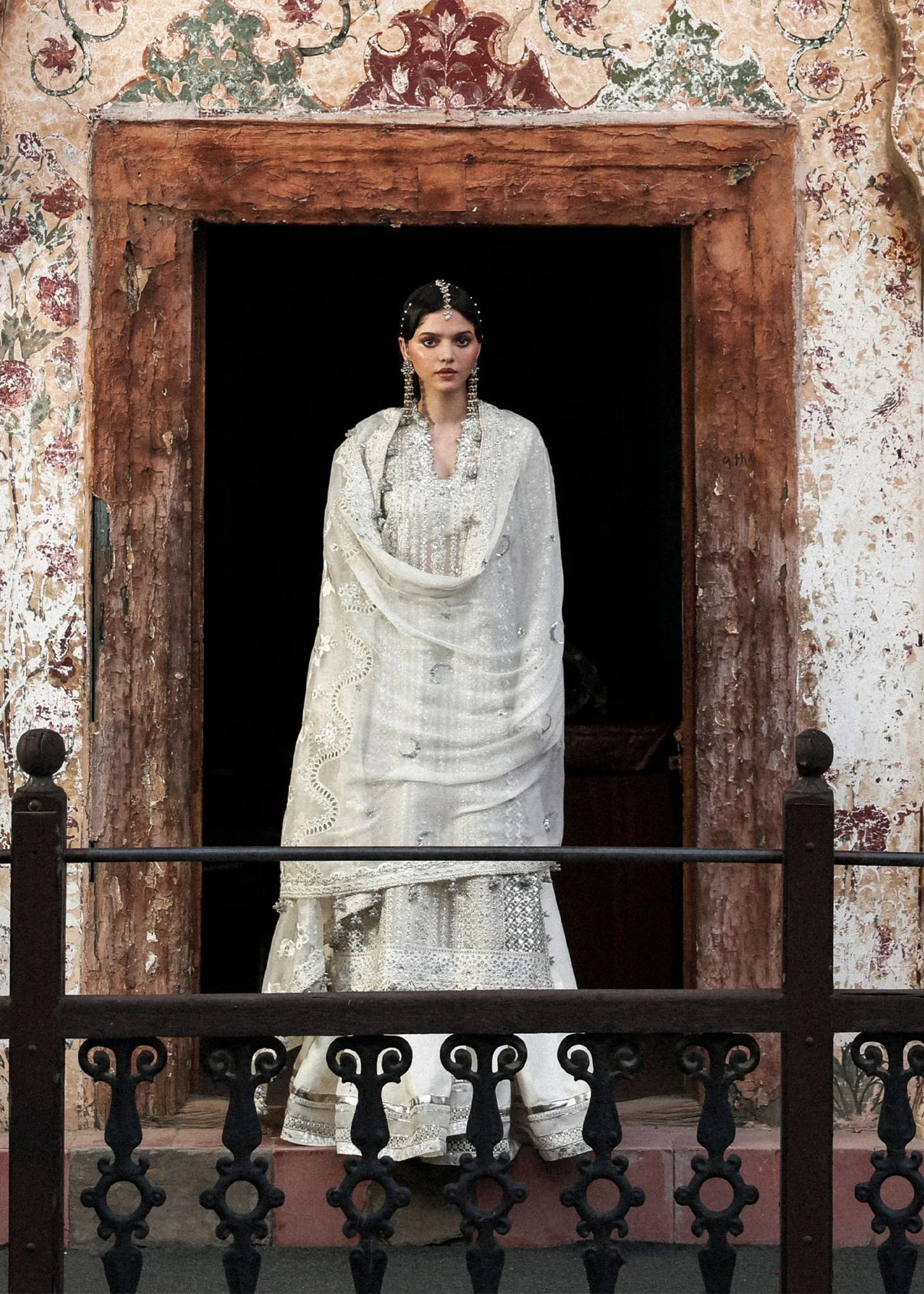 Elegant ivory organza shirt with sequin embroidery, silk sharara, and chiffon dupatta. Unstitched luxury outfit exuding timeless grace and sophistication.
