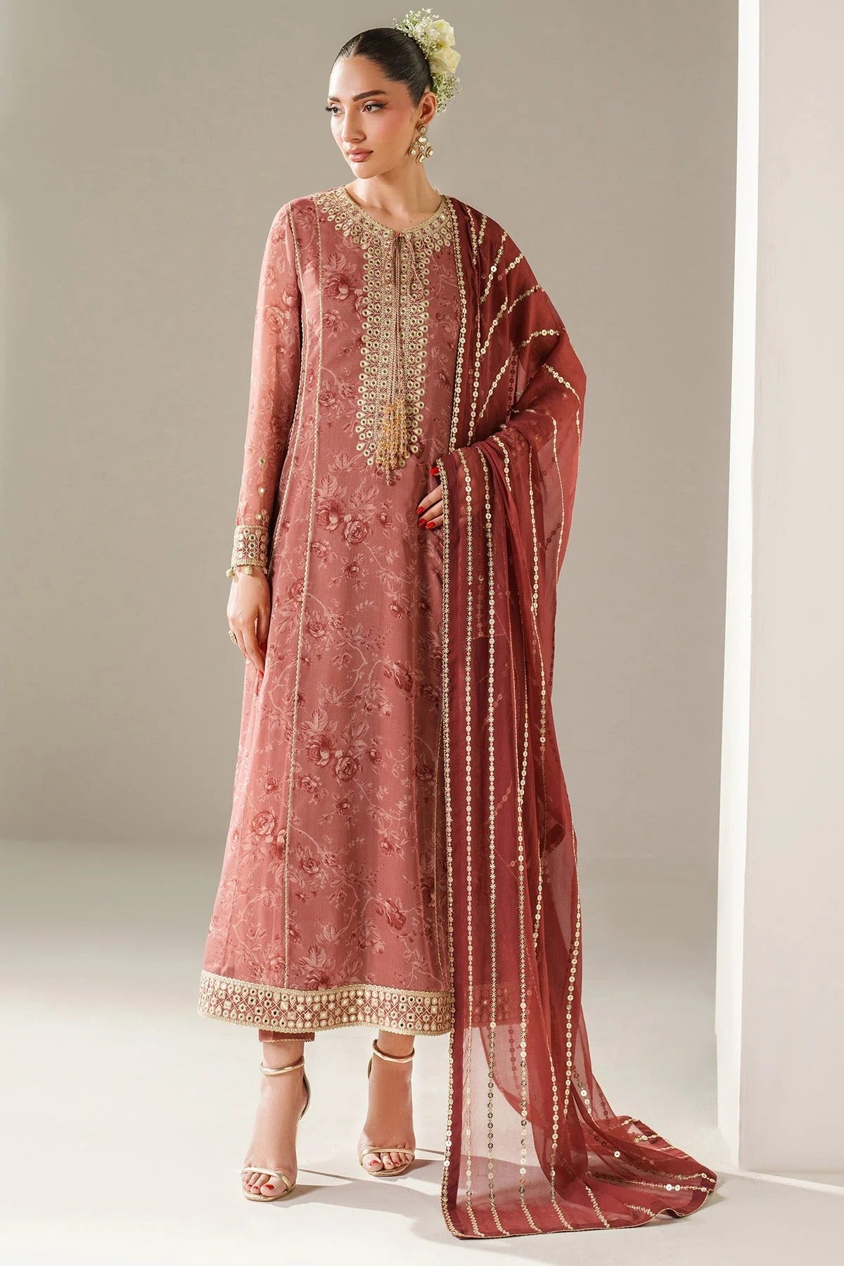 Digitally printed chiffon suit with embroidered borders & dupatta. Features rawsilk bottom for a rich, elegant look. Perfect for formal & festive wear.