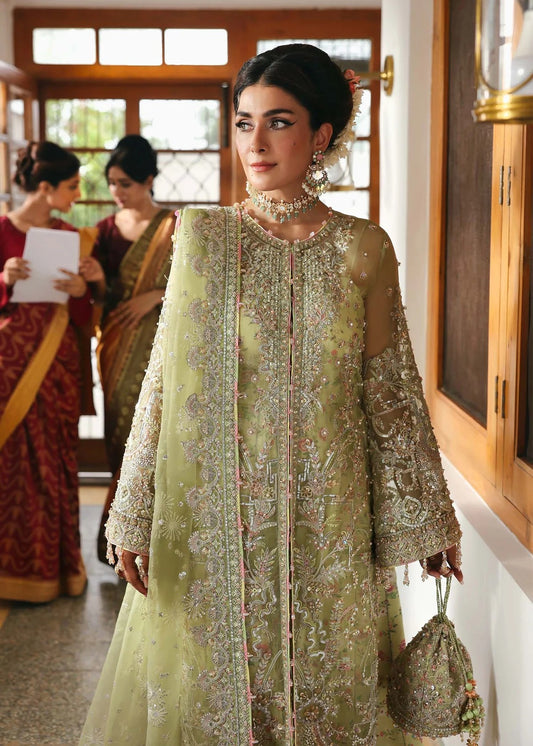 Vibrant parrot jade suit with hand-embellished organza panels, embroidered dupatta, and printed trouser—perfect for festive elegance.