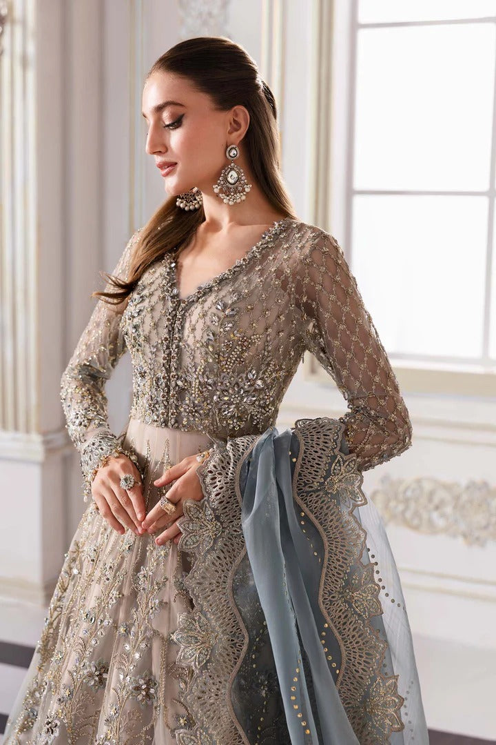 Elegant net ensemble with hand-embellished bodice, organza dupatta, and raw silk base. Perfect for weddings and formal wear. Color may slightly vary.