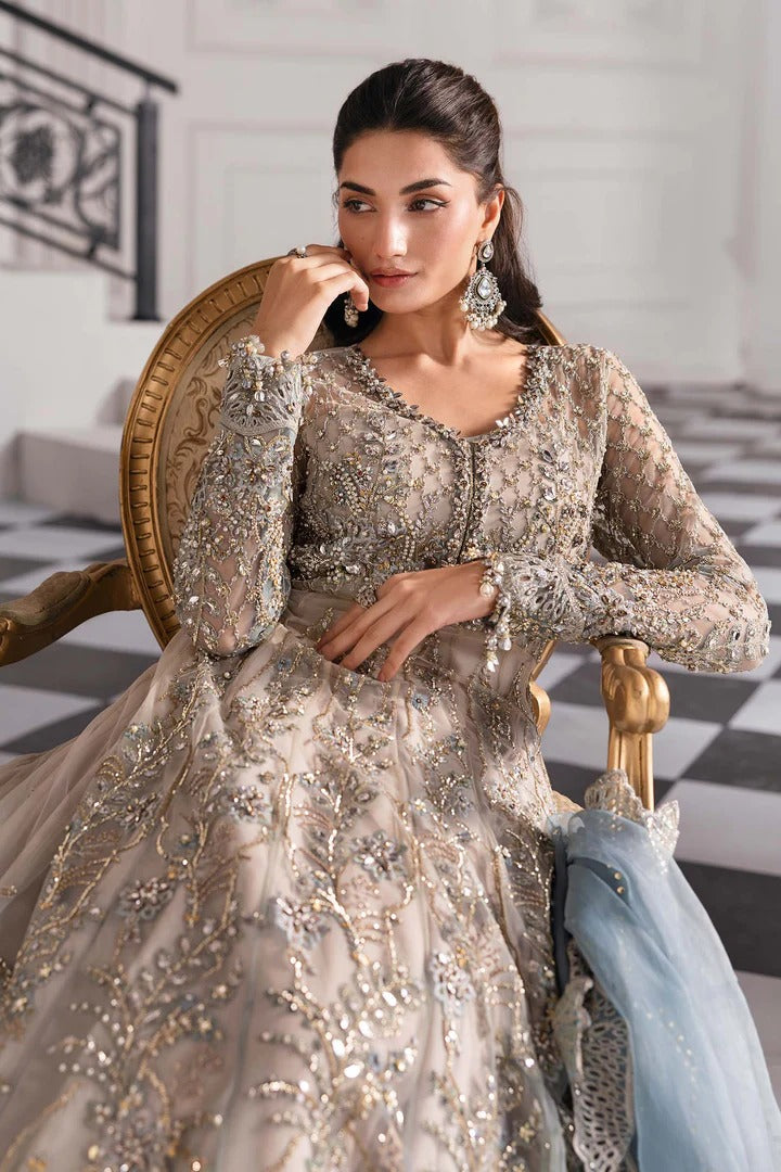 Elegant net ensemble with hand-embellished bodice, organza dupatta, and raw silk base. Perfect for weddings and formal wear. Color may slightly vary.
