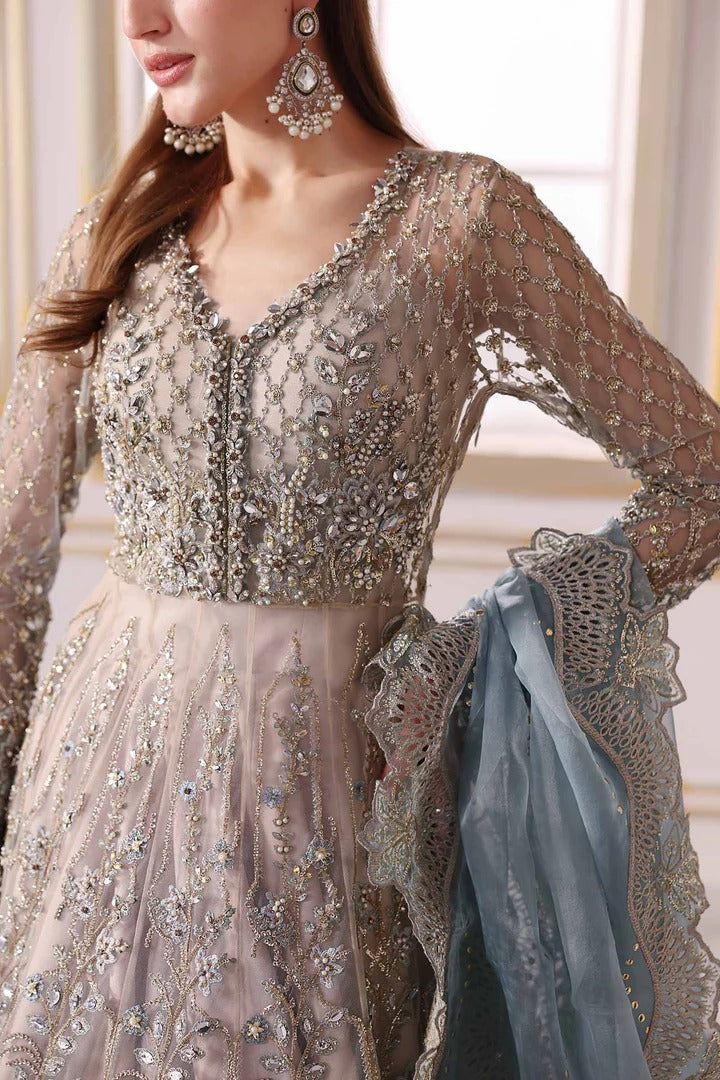 Elegant net ensemble with hand-embellished bodice, organza dupatta, and raw silk base. Perfect for weddings and formal wear. Color may slightly vary.