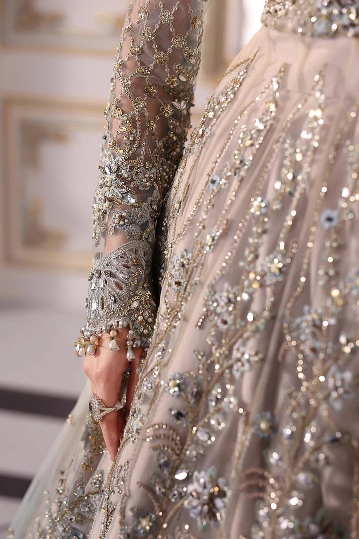 Elegant net ensemble with hand-embellished bodice, organza dupatta, and raw silk base. Perfect for weddings and formal wear. Color may slightly vary.