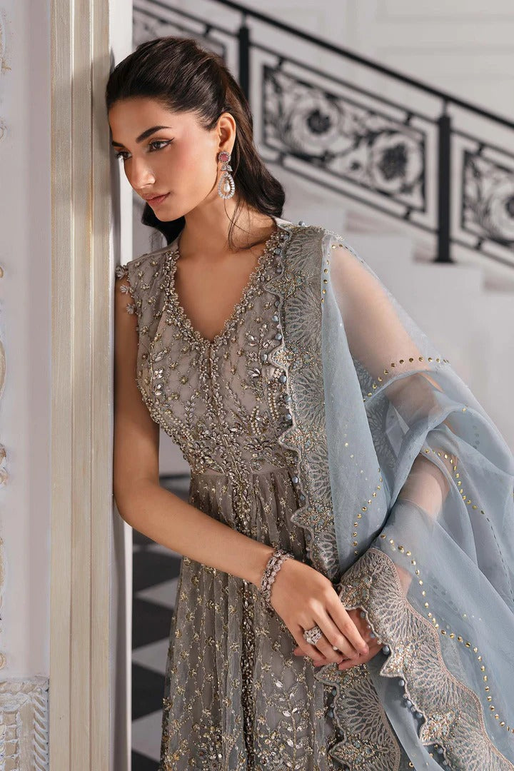Elegant net ensemble with hand-embellished bodice, organza dupatta, and raw silk base. Perfect for weddings and formal wear. Color may slightly vary.