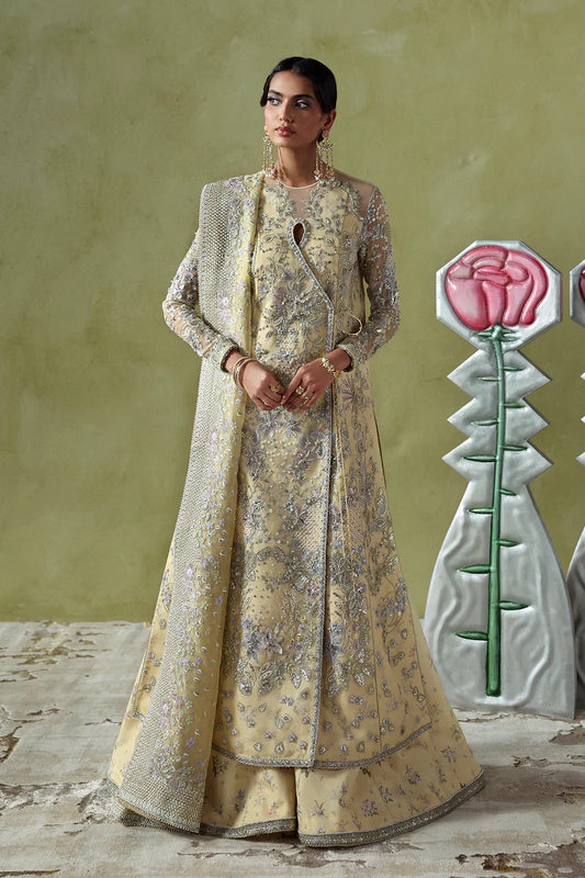 Graceful butter yellow silk suit with embroidered organza panels, embellished dupatta, and printed silk trousers. A stunning choice for festive and formal occasions.