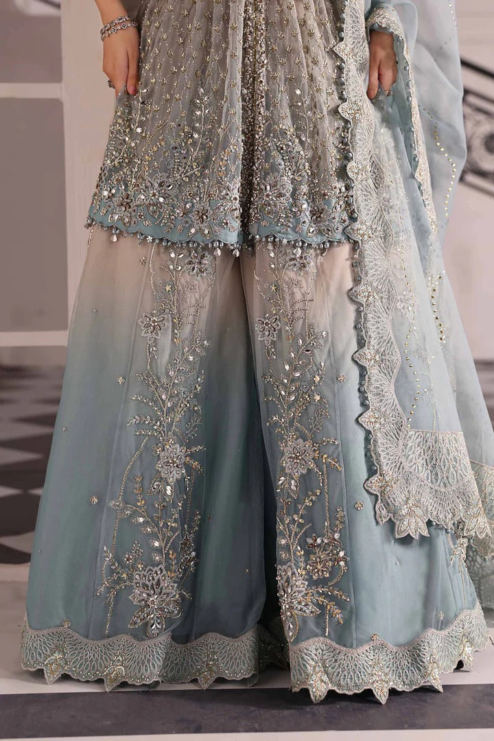 Elegant net ensemble with hand-embellished bodice, organza dupatta, and raw silk base. Perfect for weddings and formal wear. Color may slightly vary.