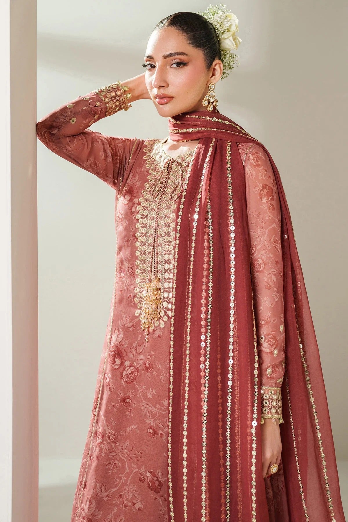 Digitally printed chiffon suit with embroidered borders & dupatta. Features rawsilk bottom for a rich, elegant look. Perfect for formal & festive wear.