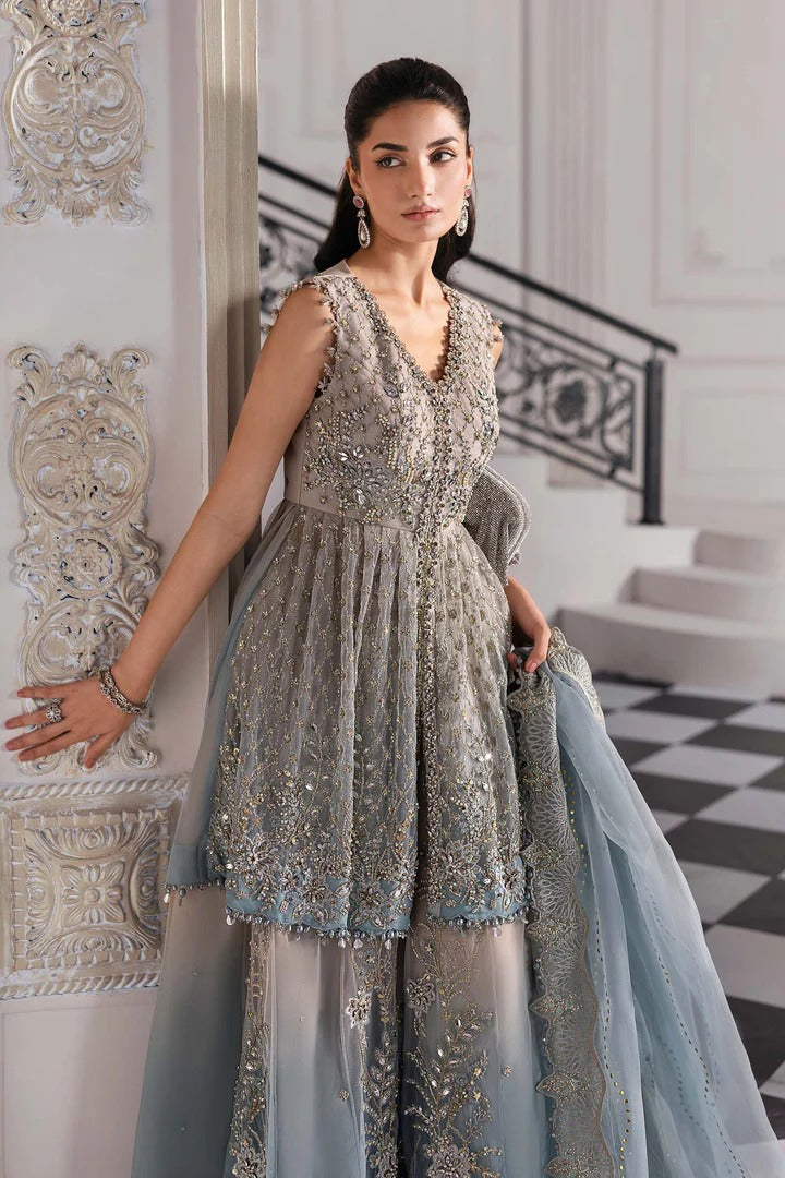 Elegant net ensemble with hand-embellished bodice, organza dupatta, and raw silk base. Perfect for weddings and formal wear. Color may slightly vary.