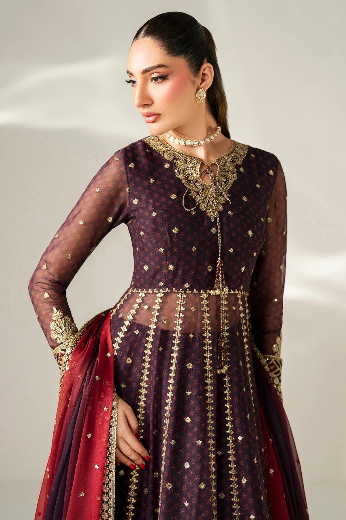 Intricately embroidered chiffon suit with digital prints, bordered dupatta, and raw silk bottom—crafted for timeless elegance and formal sophistication.