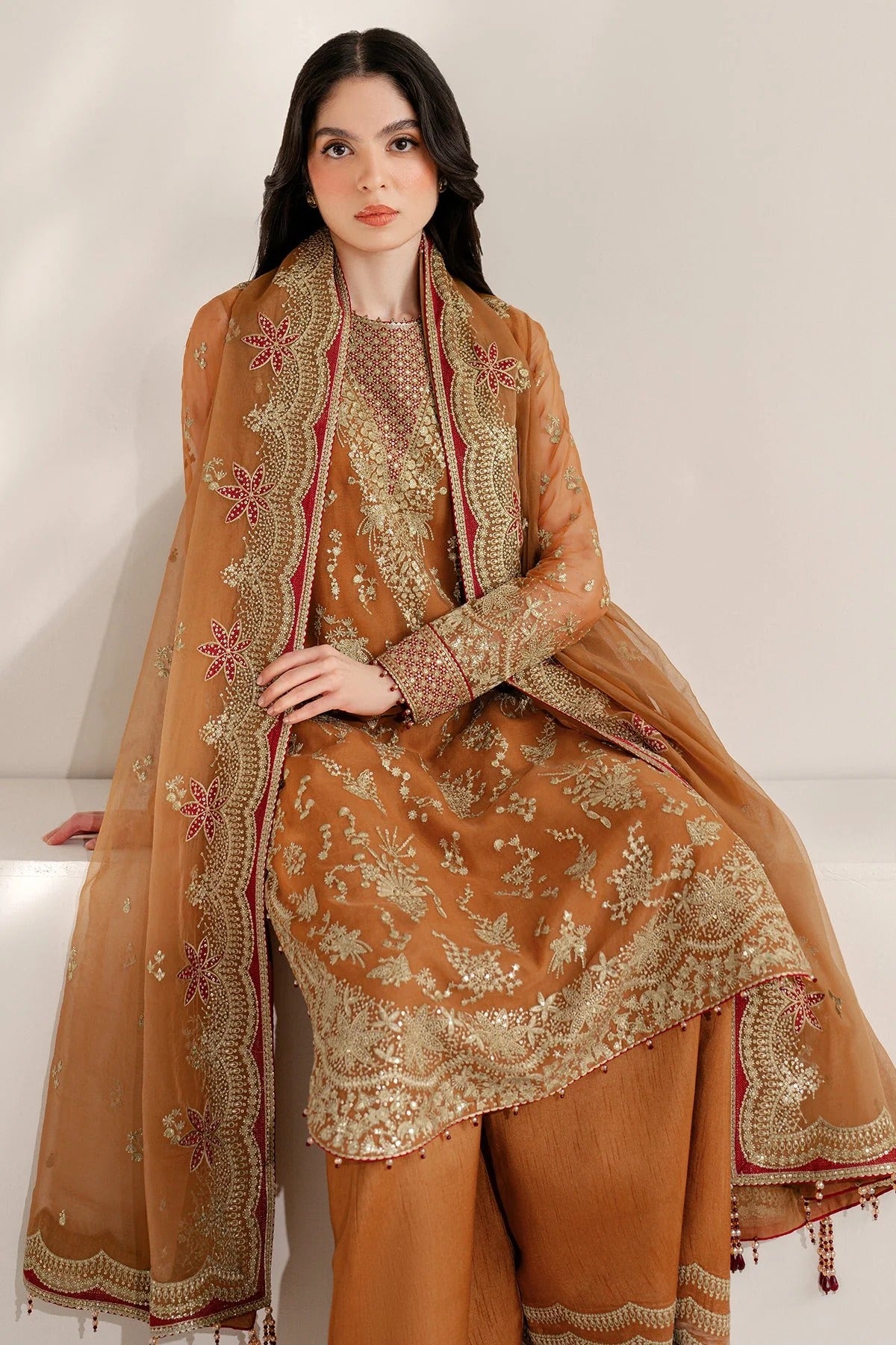 Chiffon and rawsilk elegance with intricate embroidery and organza dupatta. Ideal for formal wear and events. Make a bold style statement in UC-3077.