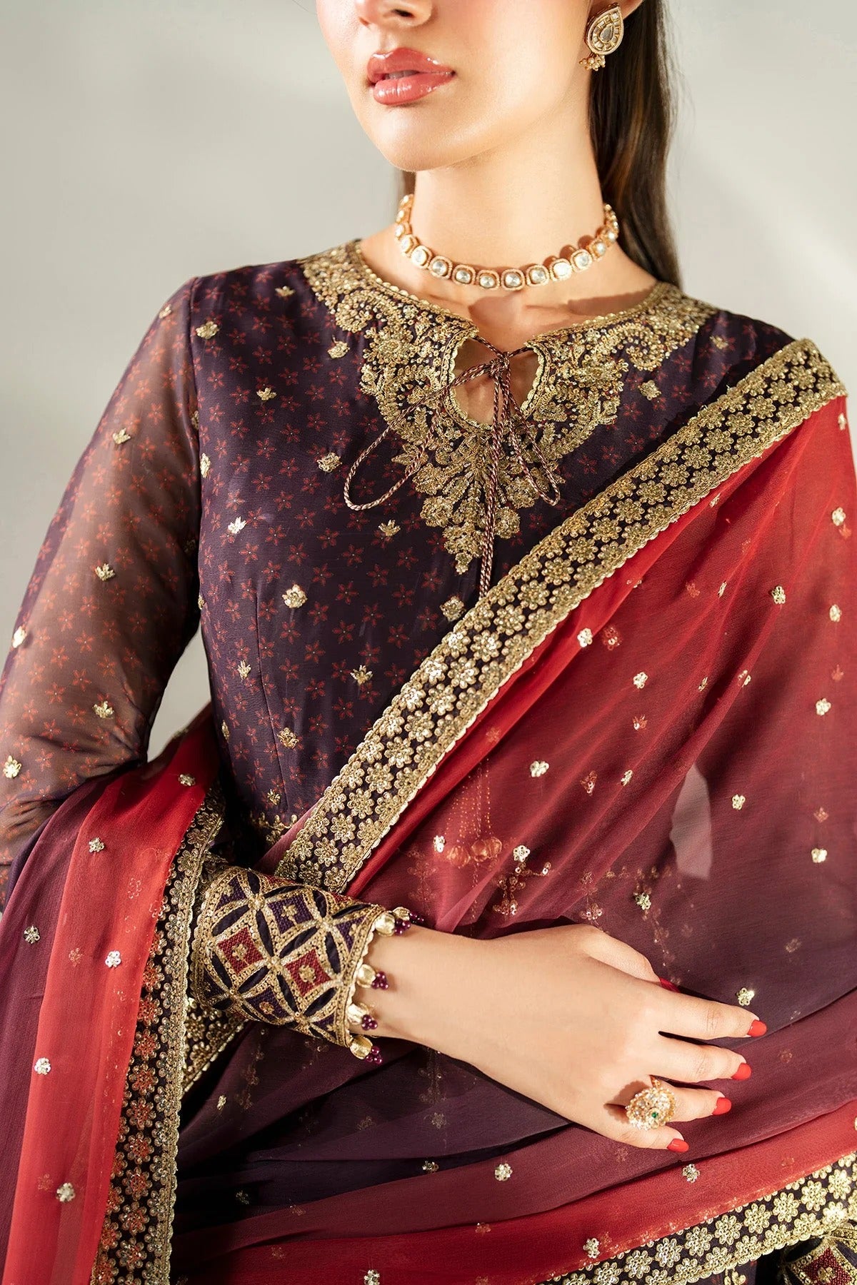 Intricately embroidered chiffon suit with digital prints, bordered dupatta, and raw silk bottom—crafted for timeless elegance and formal sophistication.