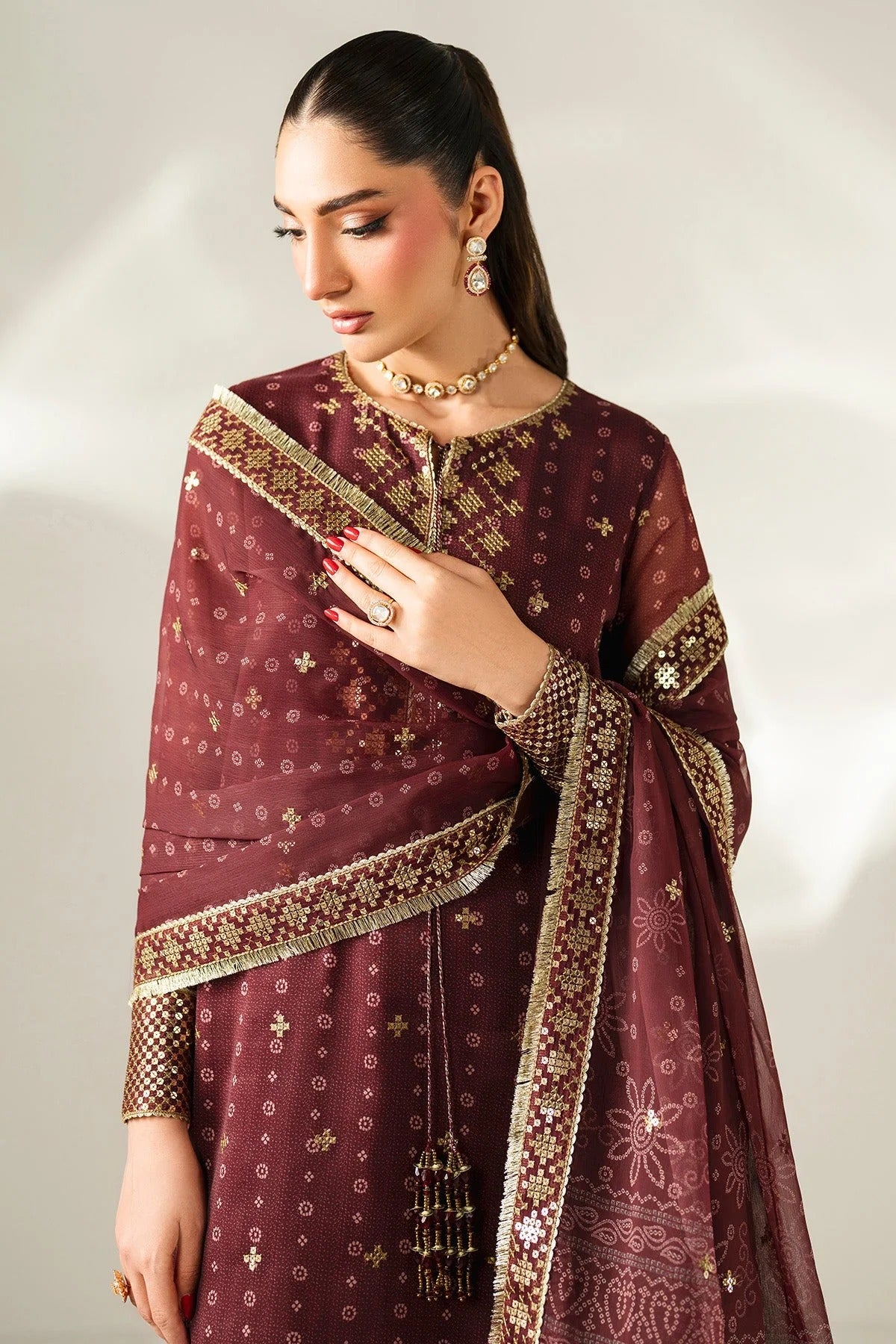Digitally printed chiffon with intricate embroidery, bordered dupatta, and dyed raw silk bottom—perfect for weddings, festive events, or formal wear.
