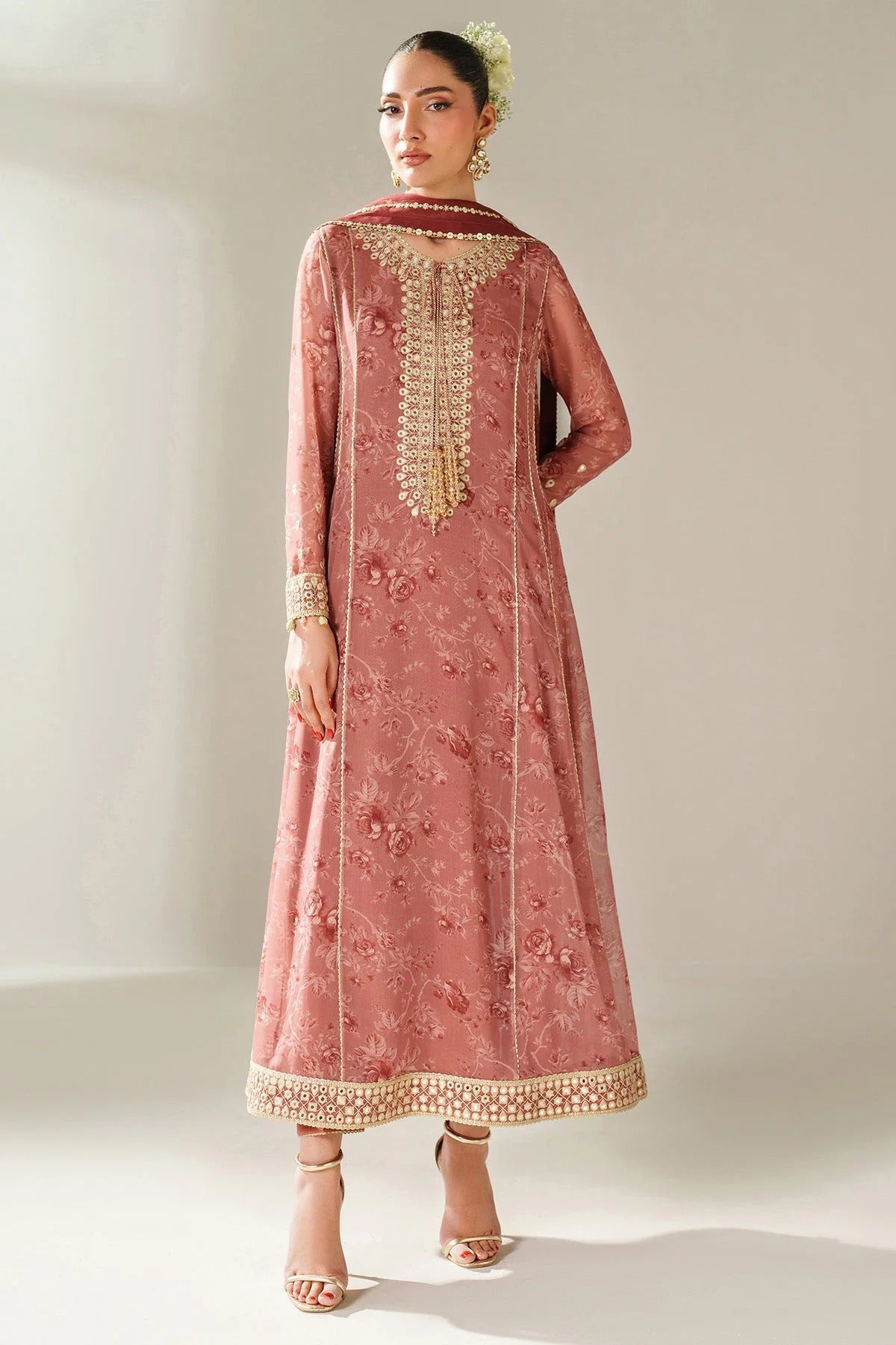 Digitally printed chiffon suit with embroidered borders & dupatta. Features rawsilk bottom for a rich, elegant look. Perfect for formal & festive wear.
