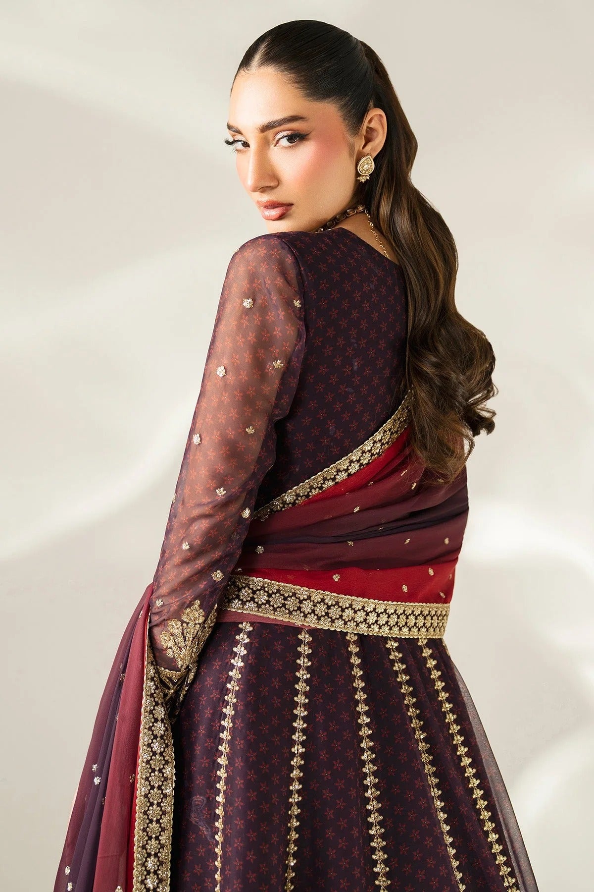 Intricately embroidered chiffon suit with digital prints, bordered dupatta, and raw silk bottom—crafted for timeless elegance and formal sophistication.