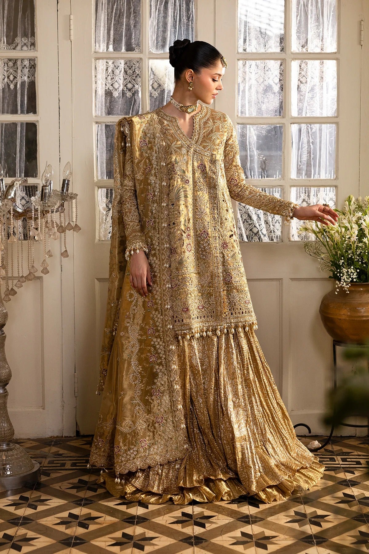 Opulent golden tissue outfit with intricate zari embroidery, dupatta, and jamavaar trousers. Ideal for weddings, formal events, or festive occasions.