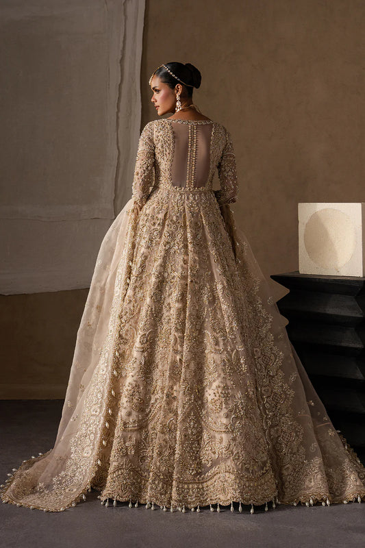 Majestic champagne bridal lehenga with hand embellishment and antique gold embroidery. Features ornate motifs, flowing skirt and elegant dupatta.