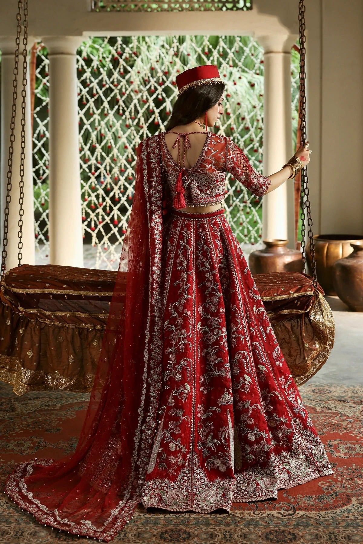 Vibrant red organza and shmoz silk embroidered panels, sleeves, dupatta, and borders paired with raw silk trousers for a bold, elegant custom outfit.