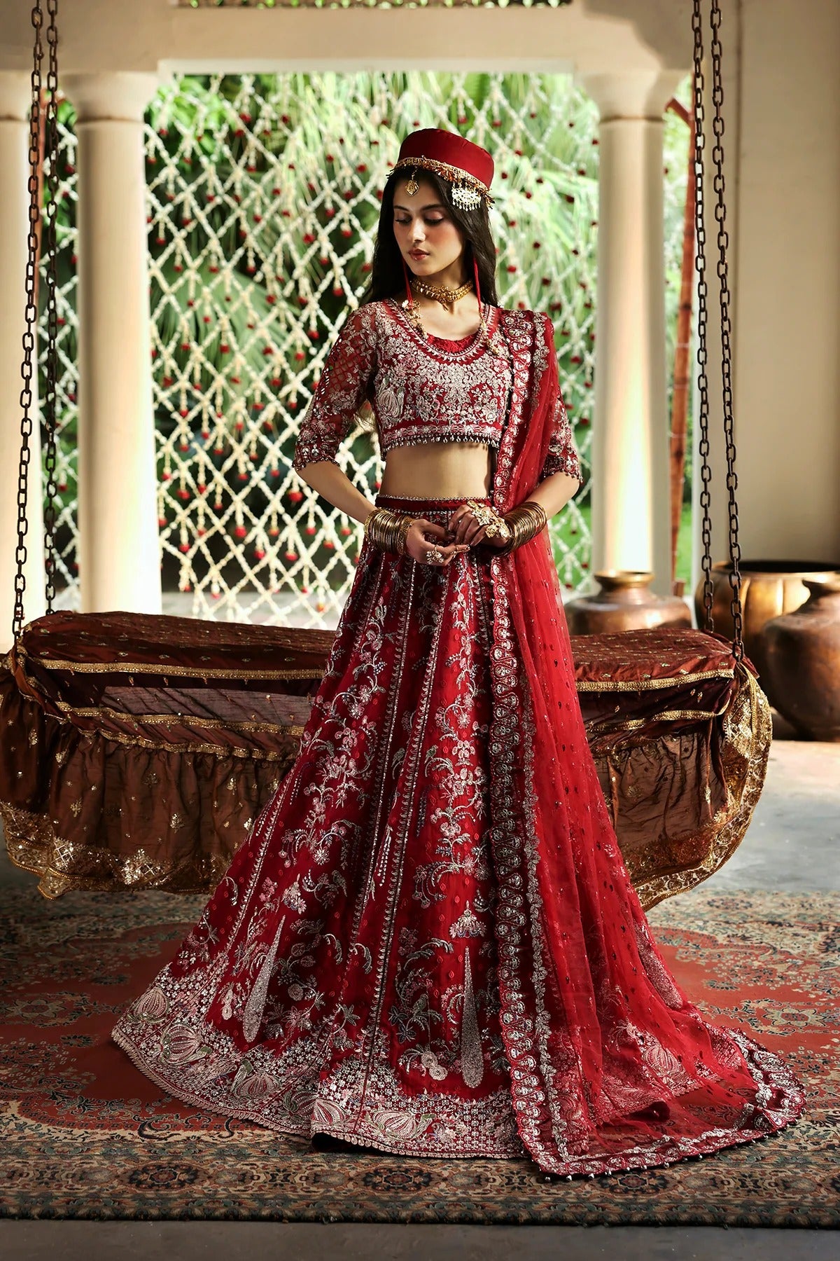 Vibrant red organza and shmoz silk embroidered panels, sleeves, dupatta, and borders paired with raw silk trousers for a bold, elegant custom outfit.