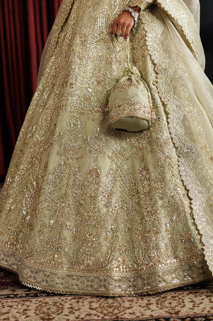 Elegant net embroidered lehenga with hand embellished panels & sleeves. Includes organza dupatta, kalli border and 6 yards inner fabric.