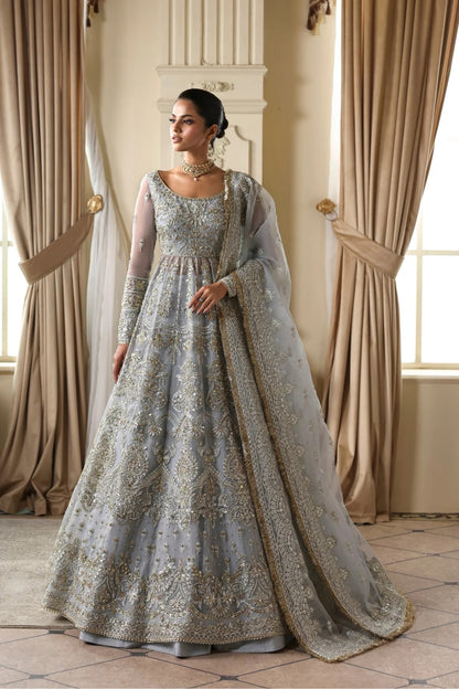 Elegant organza dress with hand embellishments, embroidered panels, matching dupatta, Russian grip inner, and 5-yard raw silk lehenga fabric. Perfect for events.