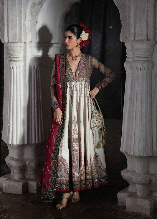 Elegant ivory embroidered pishwas with detailed panels, net sleeves, printed Korean raw silk chooridar and an embroidered Korean silk shawl for formal events.