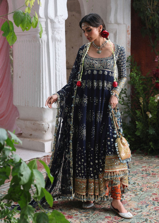 Elegant navy blue Korean raw silk pishwas with embroidered panels and sleeves, paired with printed chooridar and chiffon dupatta with four-sided borders.