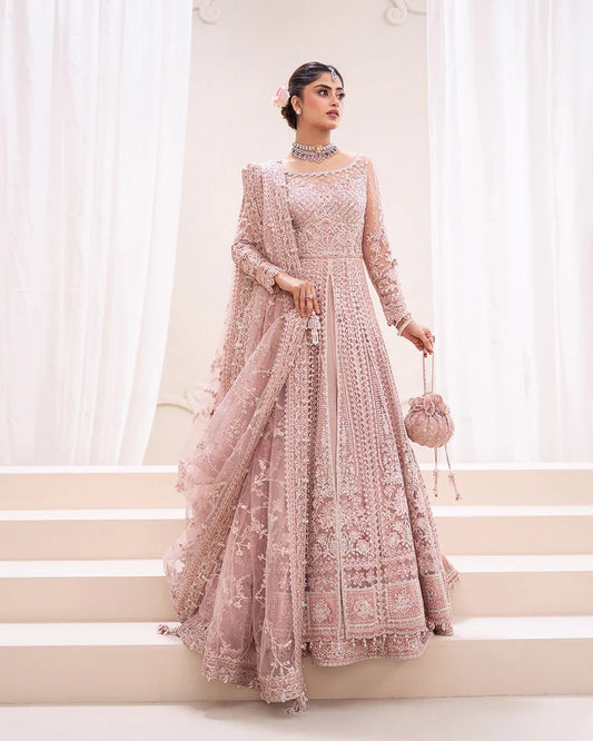 Exquisite Leyan lehenga set in dusty pink net with intricate embroidery on blouse, lehenga, and dupatta. Perfect for weddings, festive occasions, and formal events.