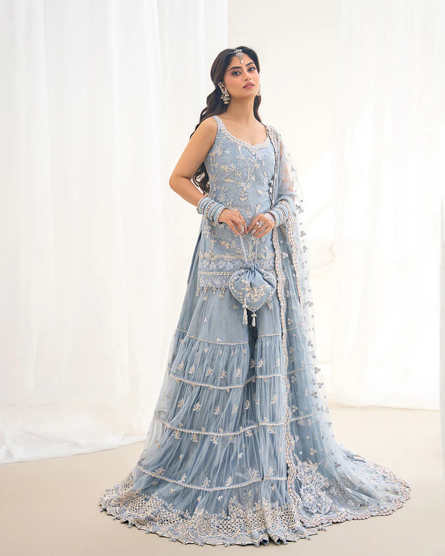 Elegant Oya gharara set in ice blue featuring intricately embroidered net shirt, gharara, and dupatta. Perfect for festive occasions and contemporary celebrations.
