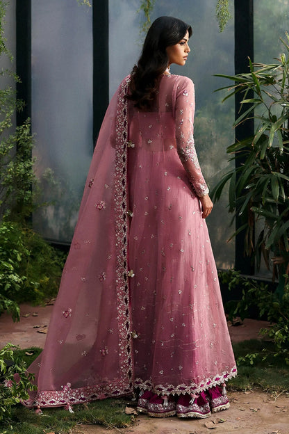 Chic pink organza dress with multi-panel embroidery, magenta silk trouser borders, and tie-dye trousers. Includes dupatta with pallu border for a vibrant look.