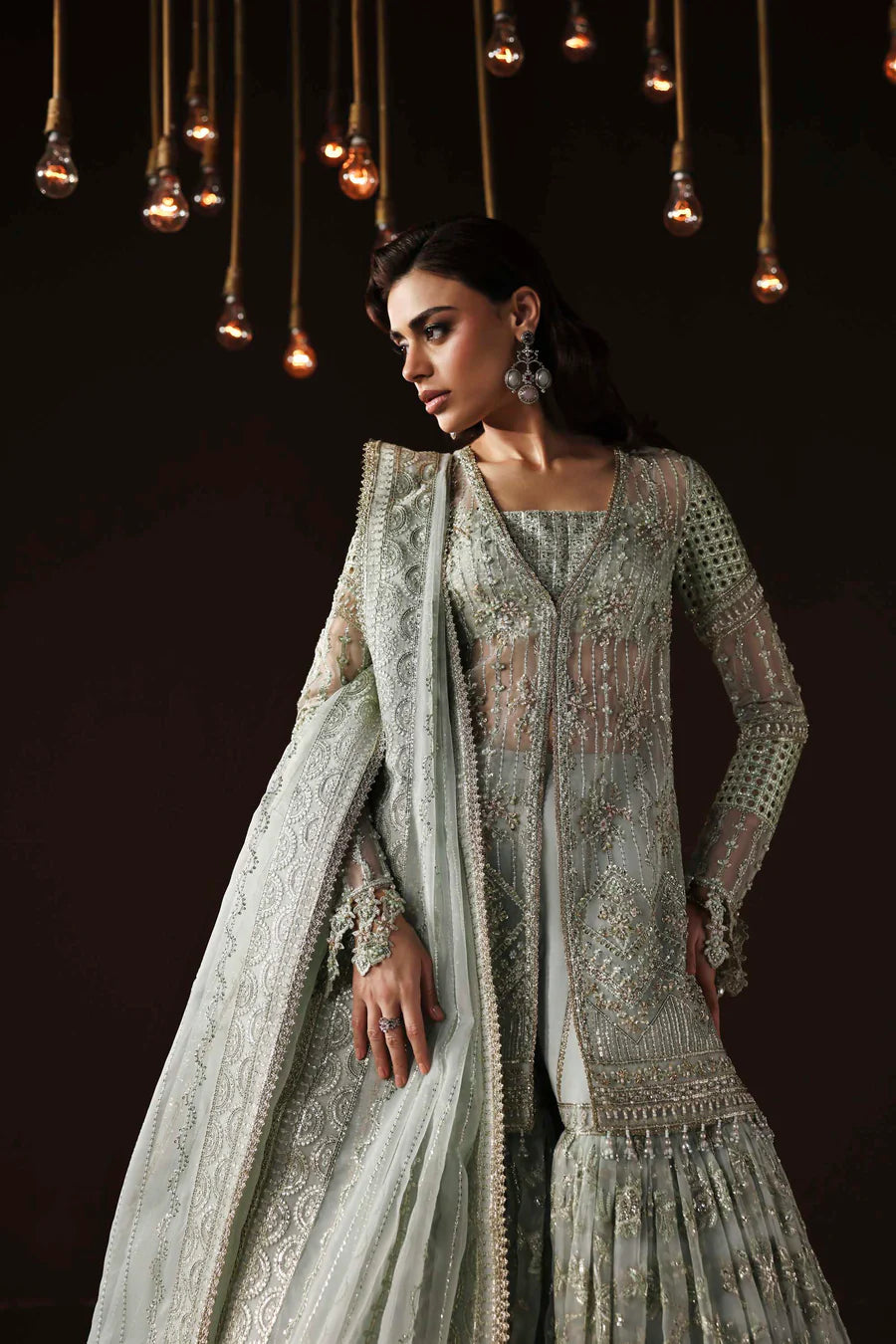 Shop organza embroidered sharara dress with hand embellishments & dupatta. Includes detailed borders & inner—perfect for weddings & festive wear.