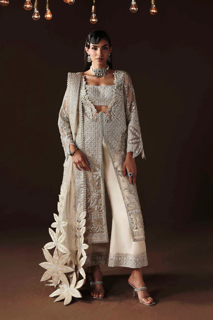 Shop organza embroidered dress with hand embellishments, raw silk trousers & dupatta. Features 3D floral details—perfect for weddings & festive wear.