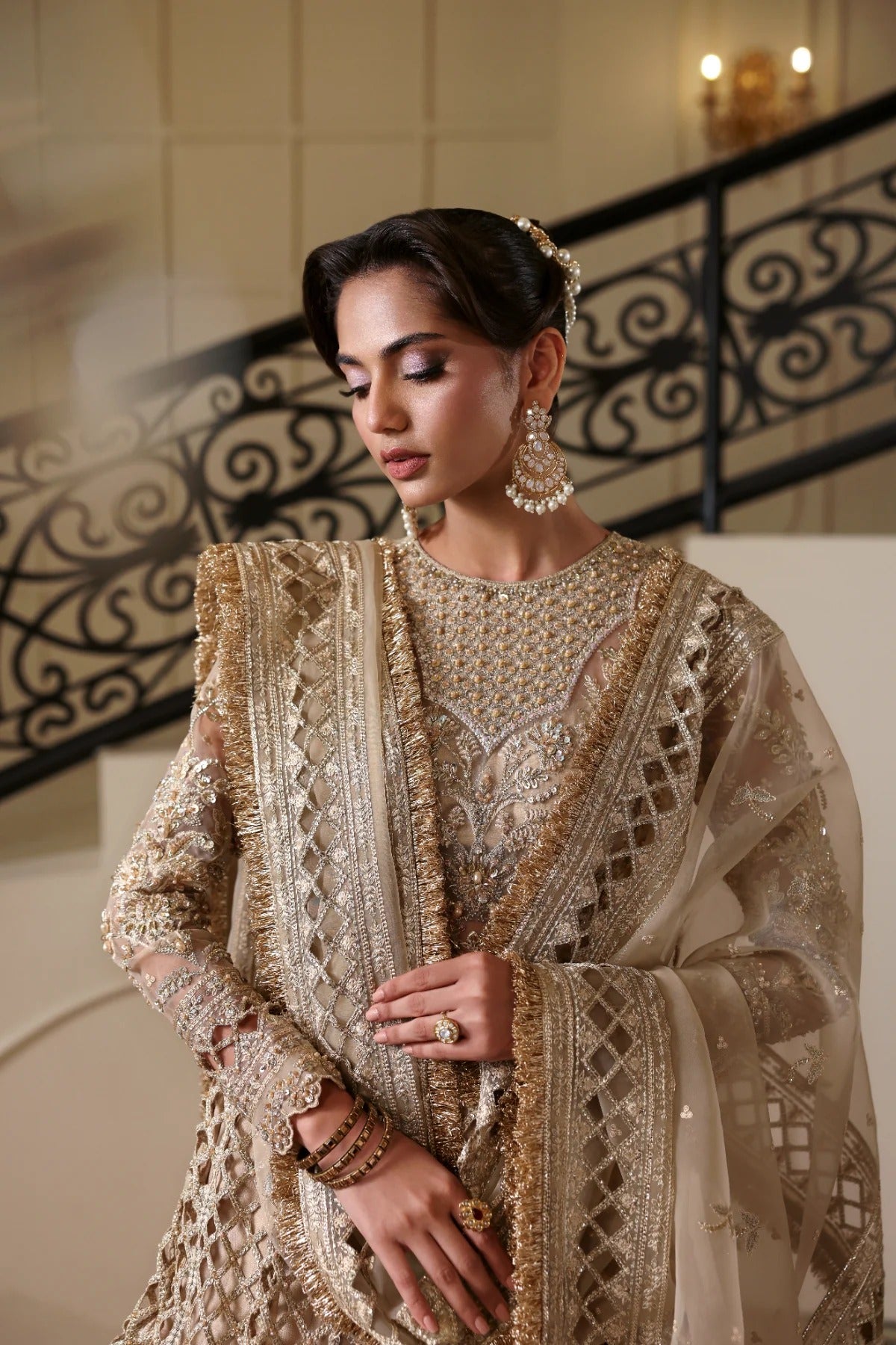 Luxurious hand-embellished organza dress with detailed panels, embroidered dupatta, Russian grip inner, and raw silk lehenga fabric for a regal ensemble.