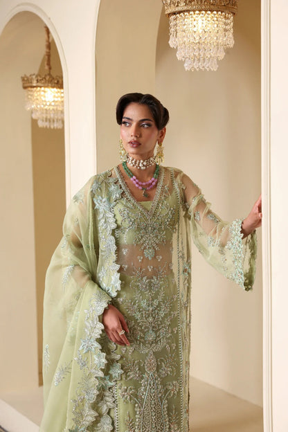 Luxurious organza suit featuring hand-embellished panels, sleeves, borders, and dupatta. Paired with Russian grip inner and 4 yards of raw silk trouser fabric.