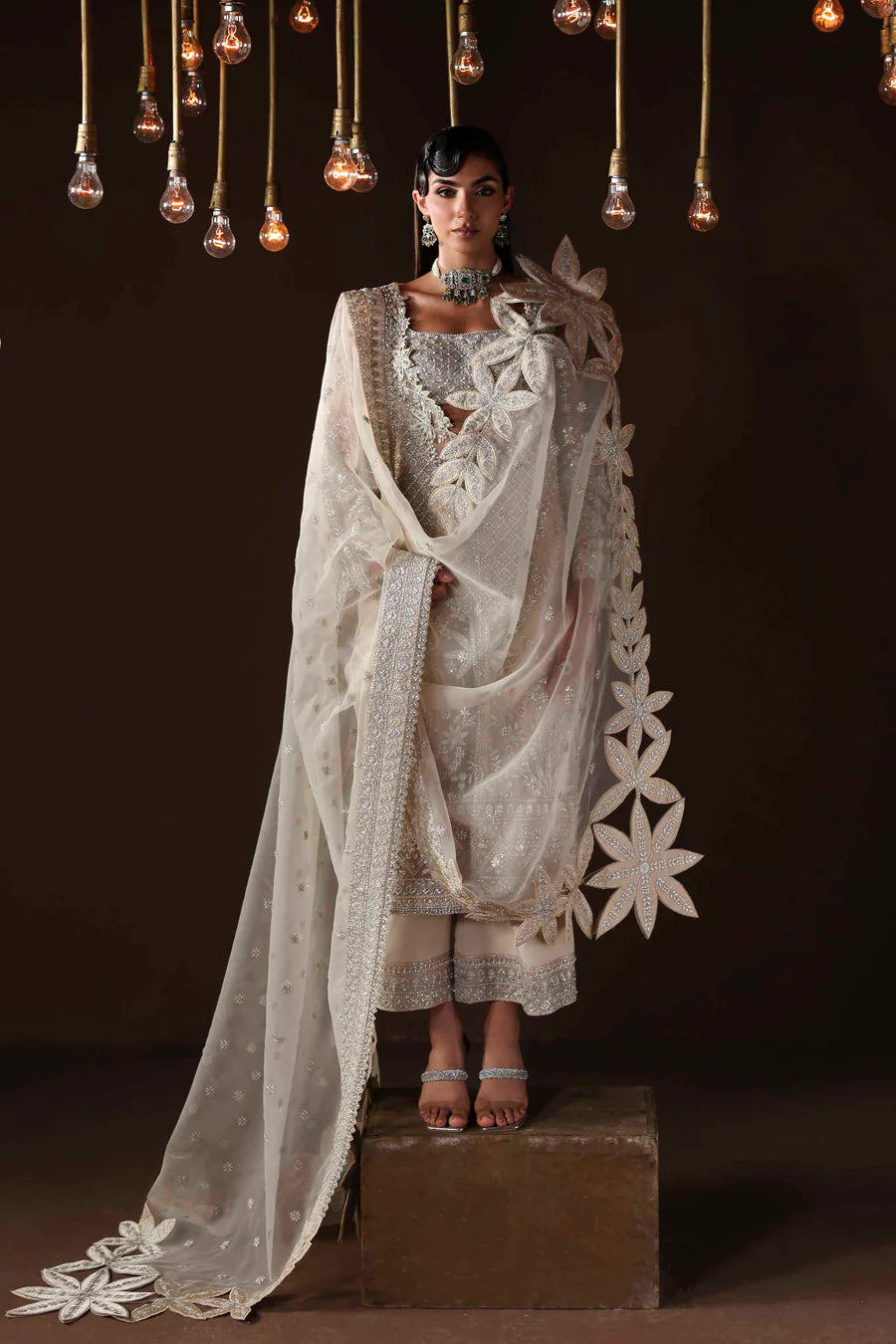 Shop organza embroidered dress with hand embellishments, raw silk trousers & dupatta. Features 3D floral details—perfect for weddings & festive wear.