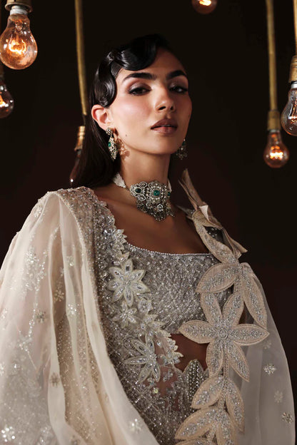 Shop organza embroidered dress with hand embellishments, raw silk trousers & dupatta. Features 3D floral details—perfect for weddings & festive wear.