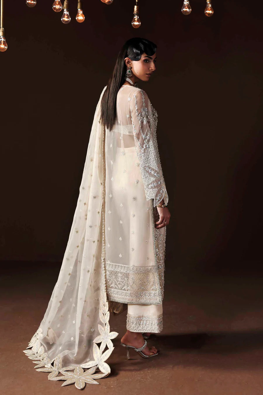 Shop organza embroidered dress with hand embellishments, raw silk trousers & dupatta. Features 3D floral details—perfect for weddings & festive wear.