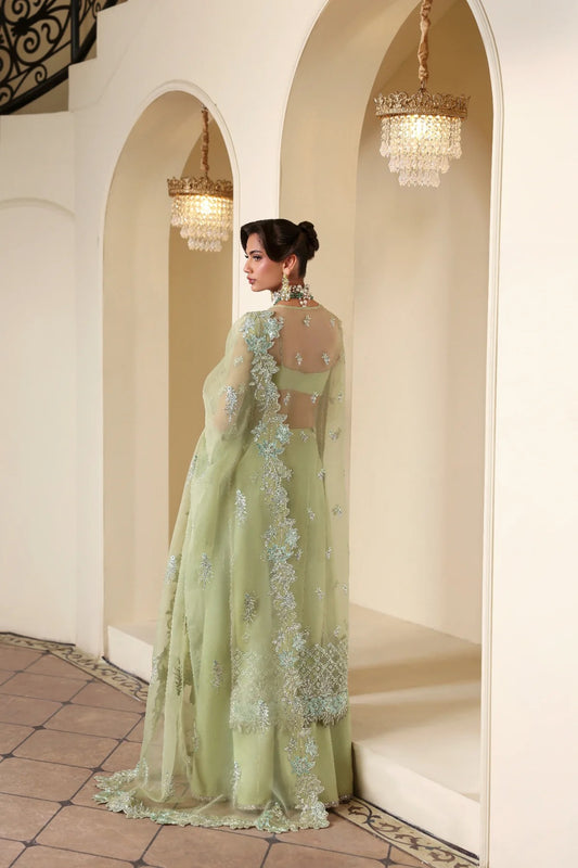 Luxurious organza suit featuring hand-embellished panels, sleeves, borders, and dupatta. Paired with Russian grip inner and 4 yards of raw silk trouser fabric.