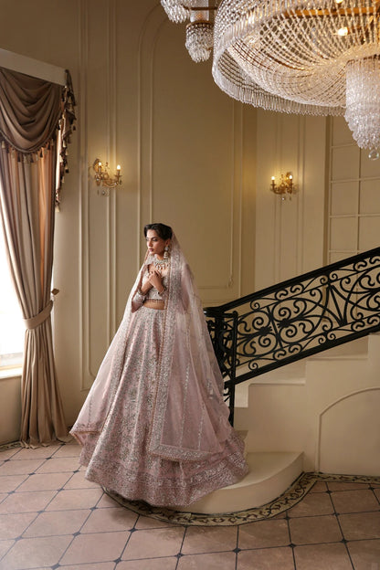 Exquisite net dress featuring hand-embellished body, sleeves, panels, and dupatta. Finished with organza kalli borders and Russian grip inner for layering.