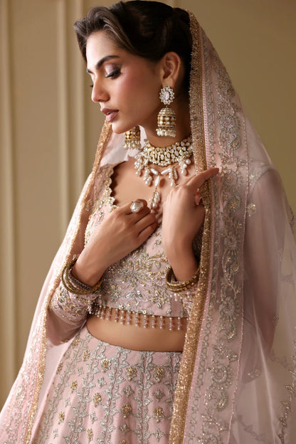 Exquisite net dress featuring hand-embellished body, sleeves, panels, and dupatta. Finished with organza kalli borders and Russian grip inner for layering.