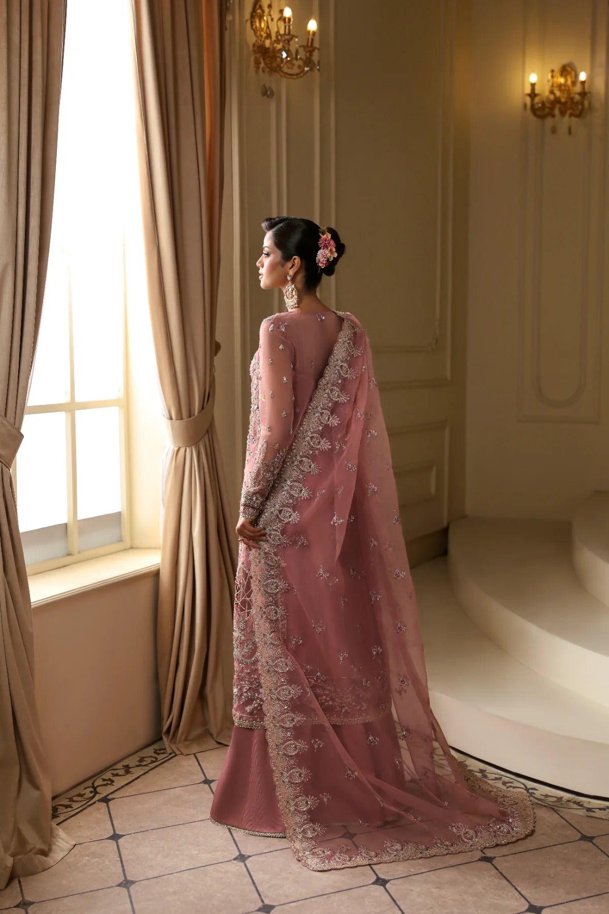 Elegant organza dress featuring hand-embellished panels, sleeves, chok patti, borders, and dupatta. Includes Russian grip inner and raw silk trouser fabric.