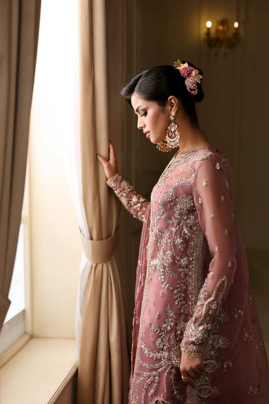 Elegant organza dress featuring hand-embellished panels, sleeves, chok patti, borders, and dupatta. Includes Russian grip inner and raw silk trouser fabric.