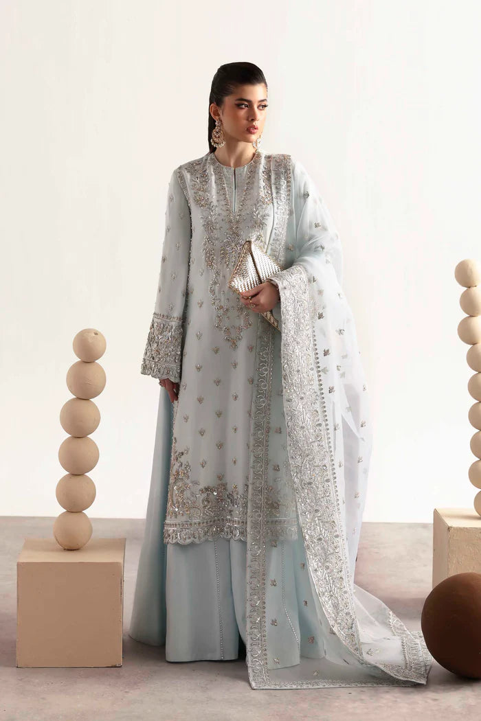 Elegant silk suit featuring hand-embroidered front, back, sleeves, chalk borders, dyed silk trouser, and a 3-yard organza dupatta for a complete festive look