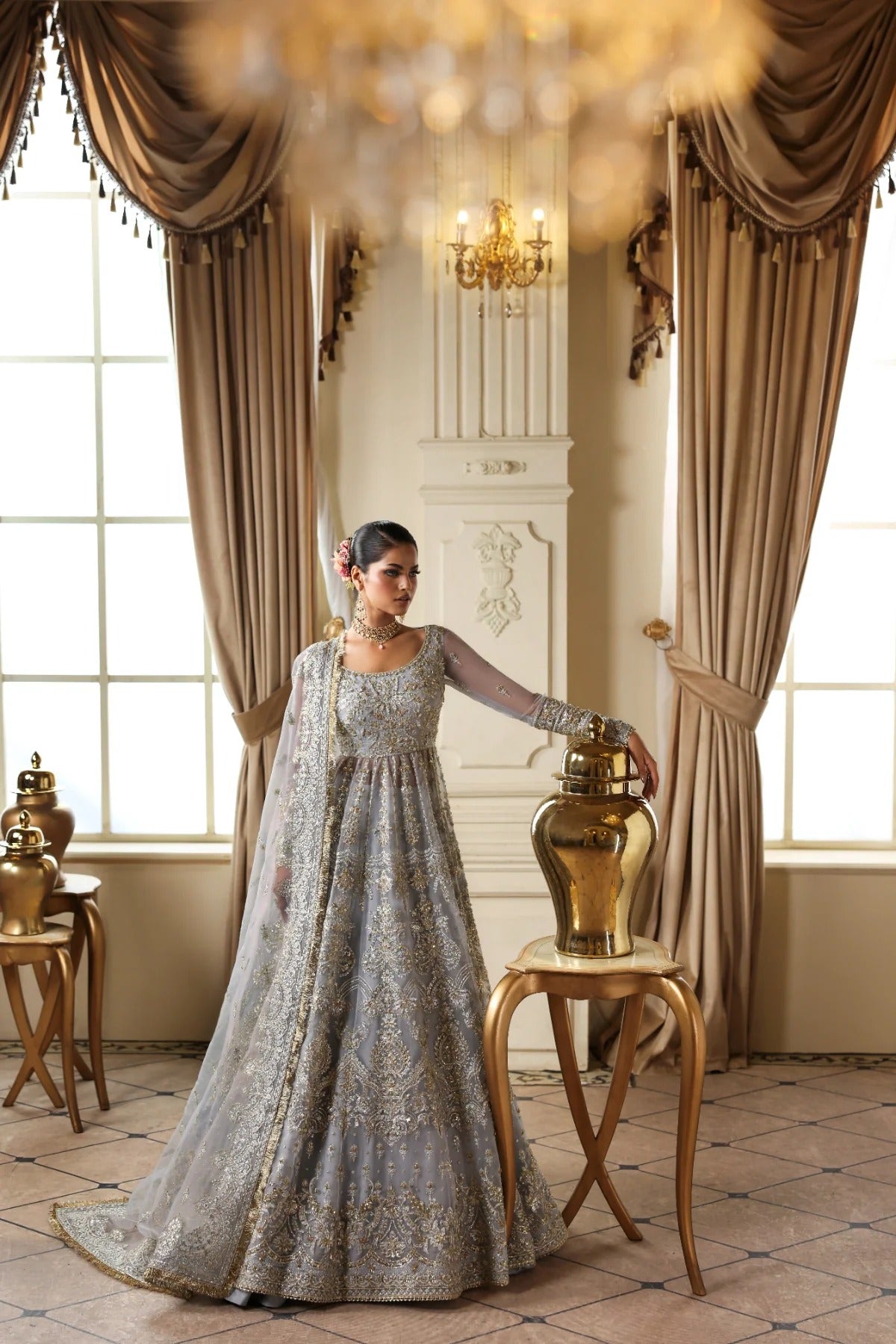 Elegant organza dress with hand embellishments, embroidered panels, matching dupatta, Russian grip inner, and 5-yard raw silk lehenga fabric. Perfect for events.