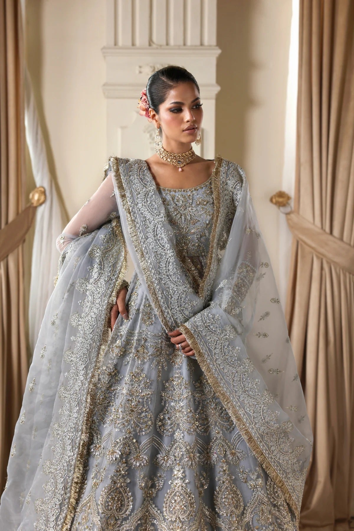 Elegant organza dress with hand embellishments, embroidered panels, matching dupatta, Russian grip inner, and 5-yard raw silk lehenga fabric. Perfect for events.