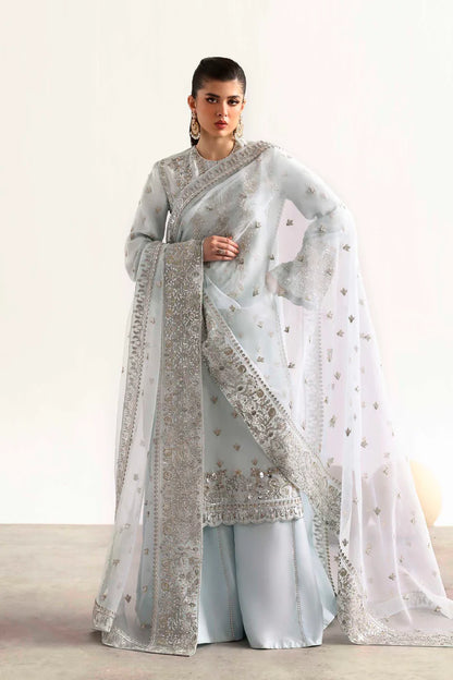 Elegant silk suit featuring hand-embroidered front, back, sleeves, chalk borders, dyed silk trouser, and a 3-yard organza dupatta for a complete festive look